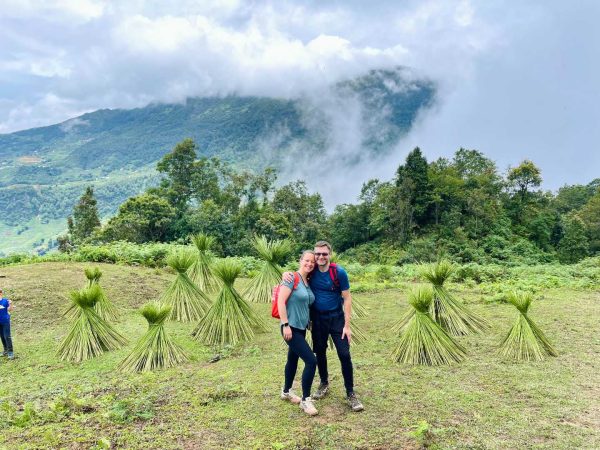 Tourist taking a photo with hemp plants used in traditional Hmong weaving
